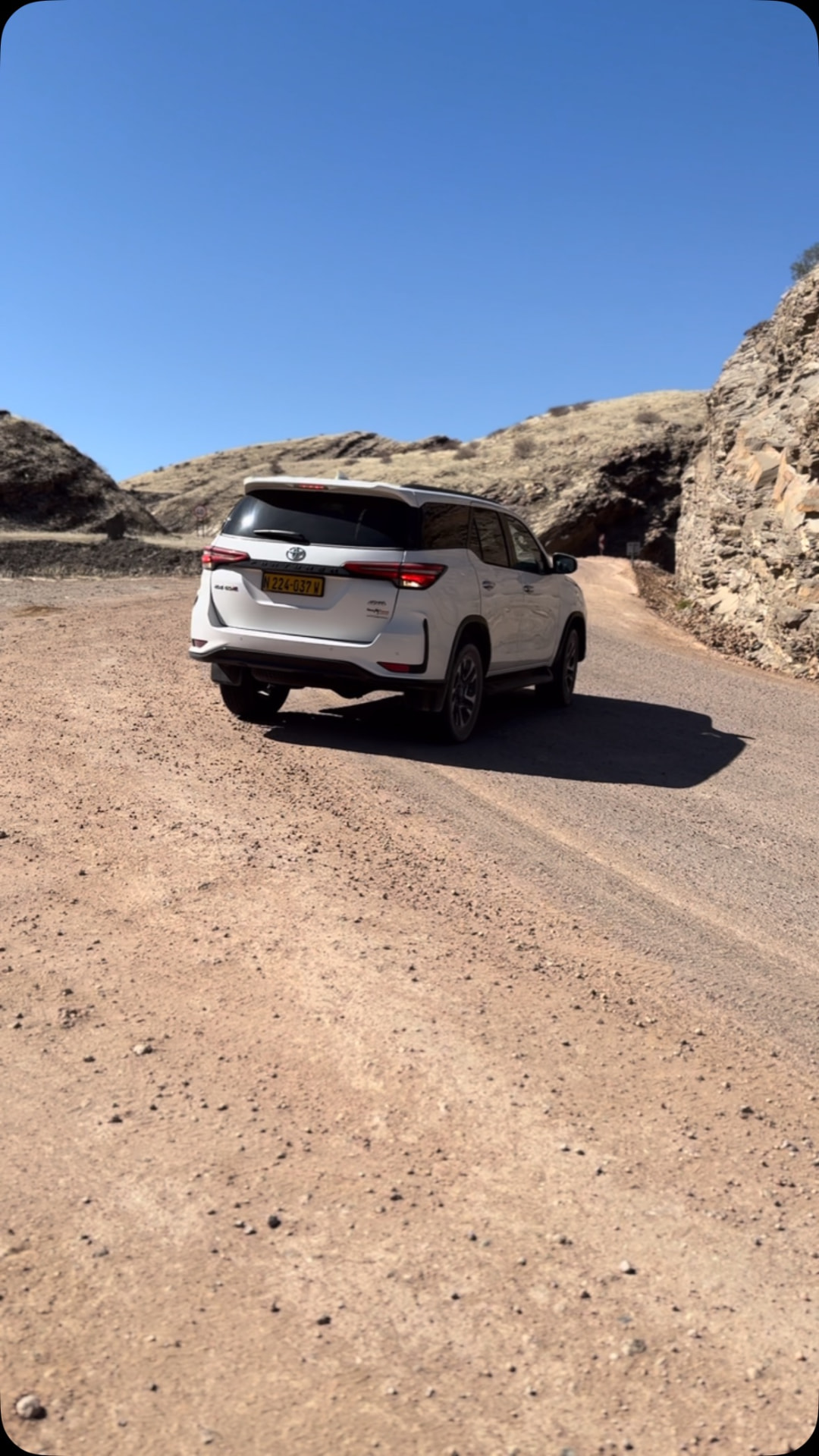 Toyota Fortuner driving through a Namibian desert canyon road